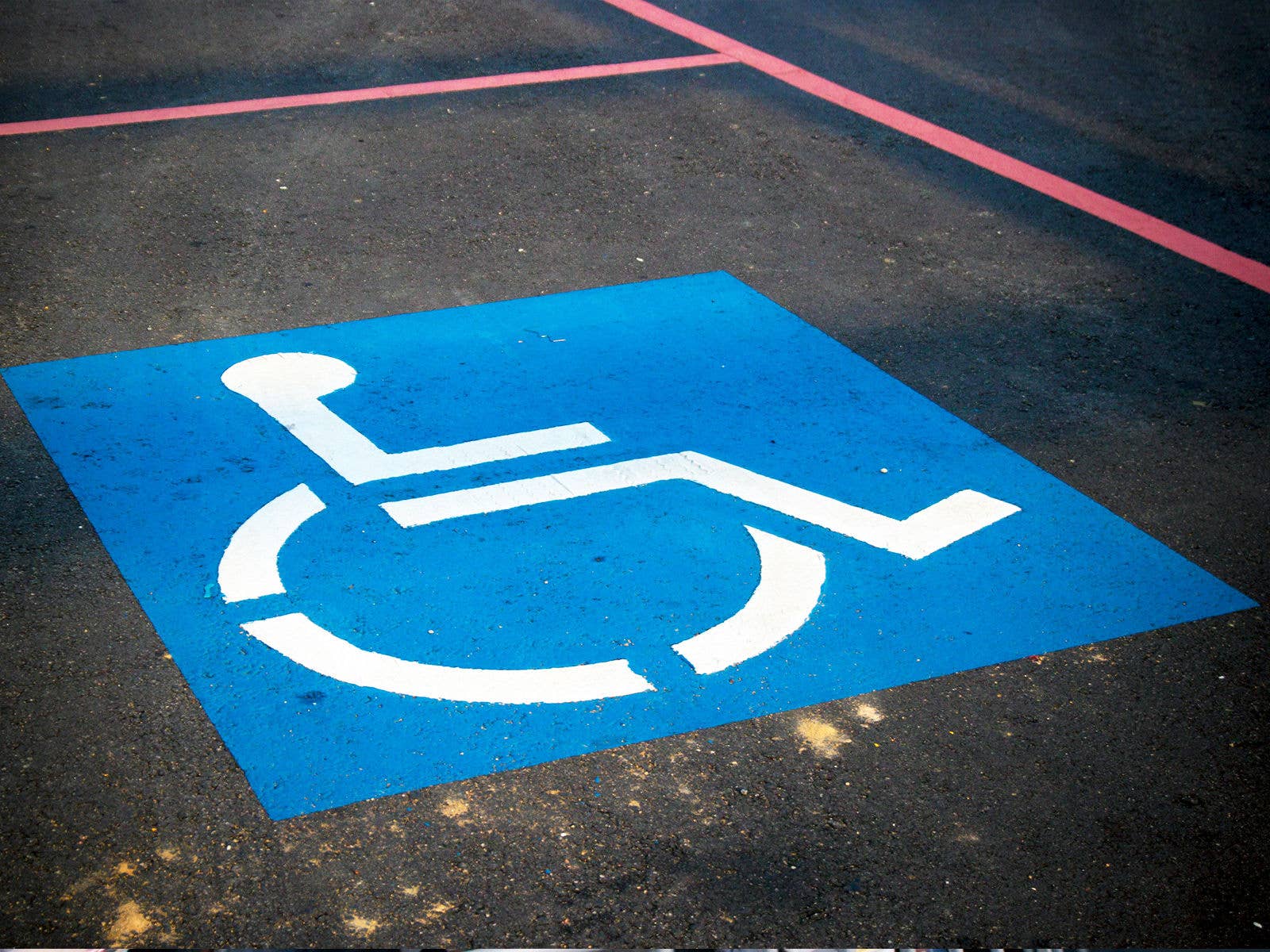 Accessible Parking Person with disability icon sign marked on the road parking spot